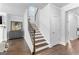 Elegant staircase with wooden steps, iron railings, and a neutral color palette at 510 Cunninghame Ct, Peachtree City, GA 30269