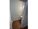 A half bath features a pedestal sink, oval mirror, and wood-look flooring at 5257 Carrie Dr, Morrow, GA 30260