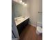 Modern bathroom featuring a double sink vanity with sleek fixtures and wood-look flooring at 5257 Carrie Dr, Morrow, GA 30260