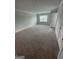 Bedroom featuring neutral carpet, a window for natural light, and white trim on the walls at 5257 Carrie Dr, Morrow, GA 30260