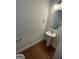 Image of half bathroom with hardwood floor and pedestal sink at 5257 Carrie Dr, Morrow, GA 30260
