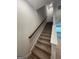 Carpeted staircase with wooden handrail leading to the next level of the house at 5257 Carrie Dr, Morrow, GA 30260