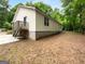 Rear view of home with a private deck and landscaped yard providing a serene outdoor space at 355 New Marietta Hwy, Roswell, GA 30075