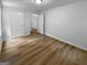Bedroom featuring wood-look floors, a closet, and access to the hallway at 355 New Marietta Hwy, Roswell, GA 30075