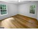 Bedroom with two windows providing natural light and wood-look flooring at 355 New Marietta Hwy, Roswell, GA 30075