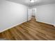 Bedroom featuring wood-look flooring, and a view of the hallway at 355 New Marietta Hwy, Roswell, GA 30075
