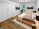 Staged bedroom with cozy decor, a large window, and ample closet space at 355 New Marietta Hwy, Roswell, GA 30075