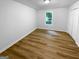 Spacious bedroom features wood-look flooring, a window, and a closet at 355 New Marietta Hwy, Roswell, GA 30075