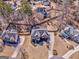 Aerial view of a traditional brick home surrounded by lush greenery and mature trees at 4213 Bretdale Nw Run, Kennesaw, GA 30152