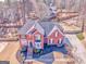Overhead view of a red brick home with a well-manicured lawn and mature trees at 4213 Bretdale Nw Run, Kennesaw, GA 30152