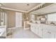 Bright bathroom boasts tile floors, a soaking tub, a glass-enclosed shower, and white cabinetry at 4213 Bretdale Nw Run, Kennesaw, GA 30152