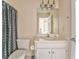 Well-lit bathroom with gray shower curtain and white vanity sink at 4213 Bretdale Nw Run, Kennesaw, GA 30152