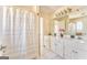 Bright bathroom with double sink vanity, tile floors, and shower with curtain at 4213 Bretdale Nw Run, Kennesaw, GA 30152