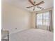 Bright, carpeted bedroom featuring a ceiling fan and a large window with curtains at 4213 Bretdale Nw Run, Kennesaw, GA 30152
