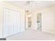 Bedroom with a ceiling fan, double closets, neutral walls, and carpet at 4213 Bretdale Nw Run, Kennesaw, GA 30152