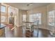 Bright dining area with large windows, a table, a fireplace, and dark hardwood flooring at 4213 Bretdale Nw Run, Kennesaw, GA 30152