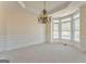 The dining room features neutral paint, white wainscotting, tray ceilings and many windows at 4213 Bretdale Nw Run, Kennesaw, GA 30152