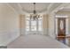 This elegant dining room features wainscoting, a bay window, and a hanging light at 4213 Bretdale Nw Run, Kennesaw, GA 30152
