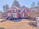 Gorgeous two-story brick home featuring manicured landscaping and classic architectural details at 4213 Bretdale Nw Run, Kennesaw, GA 30152