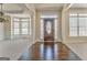 Elegant foyer featuring hardwood floors, crown molding, and a decorative front door with sidelights at 4213 Bretdale Nw Run, Kennesaw, GA 30152