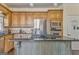Kitchen with wood cabinets, granite counters, stainless appliances, and island cooktop at 4213 Bretdale Nw Run, Kennesaw, GA 30152