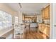 Eat-in kitchen with wood cabinets, granite counters, stainless appliances, and hardwood floors at 4213 Bretdale Nw Run, Kennesaw, GA 30152