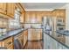 Kitchen with wood cabinets, granite counters, stainless appliances, and a sink at 4213 Bretdale Nw Run, Kennesaw, GA 30152
