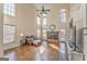 A sunny living room features hard wood floors, a fireplace and large windows for viewing at 4213 Bretdale Nw Run, Kennesaw, GA 30152