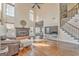 A sunny living room with a fireplace, hardwood floors and adjacent staircase for access at 4213 Bretdale Nw Run, Kennesaw, GA 30152