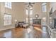 A great room is flooded with light from large windows and has wood floors and a fireplace at 4213 Bretdale Nw Run, Kennesaw, GA 30152