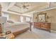 Spacious main bedroom features tray ceilings, a ceiling fan, and a large, decorative dresser with mirror at 4213 Bretdale Nw Run, Kennesaw, GA 30152