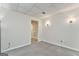 Carpeted flex space with door and sconce lighting, perfect for an office or guest room at 4213 Bretdale Nw Run, Kennesaw, GA 30152