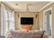 Cozy sitting room featuring neutral colors, a decorative chandelier, and a comfortable brown armchair at 4213 Bretdale Nw Run, Kennesaw, GA 30152
