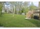 Spacious, well-maintained backyard featuring a lawn and a wooden deck with stairs leading to the house at 474 Autumn Dr, Riverdale, GA 30274