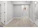 Spacious basement with light wood flooring and access to bathroom and stairway at 474 Autumn Dr, Riverdale, GA 30274
