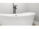 Freestanding modern bathtub with black faucet fixture at 474 Autumn Dr, Riverdale, GA 30274
