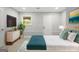 Bedroom featuring a large bed, neutral decor, a plant, and dresser at 474 Autumn Dr, Riverdale, GA 30274