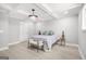 Bright bedroom featuring modern light fixture, gray walls, and light wood flooring at 474 Autumn Dr, Riverdale, GA 30274