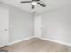 A bright bedroom featuring neutral tones, wood floors, and a white painted door at 474 Autumn Dr, Riverdale, GA 30274