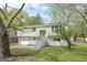 Split-level home featuring a well-maintained lawn, a two-car garage, and updated gray siding at 474 Autumn Dr, Riverdale, GA 30274