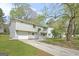 Charming split-level house with a two-car garage, neutral siding, and a well-maintained front lawn at 474 Autumn Dr, Riverdale, GA 30274
