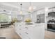 Open-concept kitchen and living area with island, modern appliances, and stylish decor at 474 Autumn Dr, Riverdale, GA 30274
