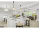Spacious kitchen island with white marble top, barstool seating, and pendant lighting at 474 Autumn Dr, Riverdale, GA 30274
