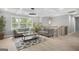 Bright living room with large windows, gray sofa, modern lighting, and stylish decor at 474 Autumn Dr, Riverdale, GA 30274