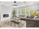 Cozy living room features a modern fireplace, plush seating, and ample natural light at 474 Autumn Dr, Riverdale, GA 30274