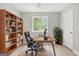 Bright home office with hardwood floors, built-in bookcase, and a large window offering backyard views at 474 Autumn Dr, Riverdale, GA 30274