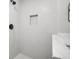 Modern walk-in shower featuring hexagon tile, matte black fixtures, and a built-in niche at 474 Autumn Dr, Riverdale, GA 30274