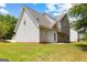 Exterior back of home and yard has a small concrete patio and green space at 4506 White Rd, Douglasville, GA 30135