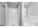 Bathroom showcasing tile-surround tub and a separate standing shower with wooden floor at 4506 White Rd, Douglasville, GA 30135