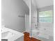 Bright bathroom featuring wood-look flooring, a tub, and a separate shower at 4506 White Rd, Douglasville, GA 30135